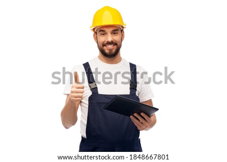 profession, construction and building - happy smiling male worker or builder in yellow helmet and overall with tablet pc computer showing thumbs up over white background