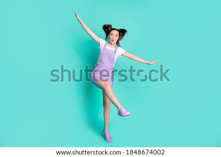 Full length body size photo of careless playful girl pretending plane with wings isolated on vibrant teal color background
