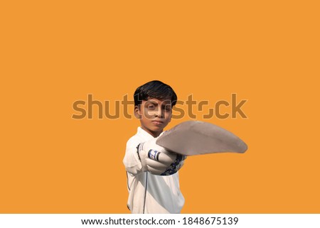 Portrait of boy celebrating his success in cricket
