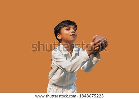 Indian Boy catching cricket ball