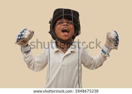 Portrait of boy celebrating his success in cricket Royalty-Free Stock Photo #1848675238