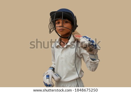 Confident boy wearing cricket helmet and ready for playing Royalty-Free Stock Photo #1848675250