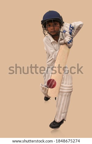 A boy in cricket uniform playing Cricket Royalty-Free Stock Photo #1848675274