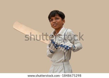 Portrait of boy wearing cricket Glove and holding bat