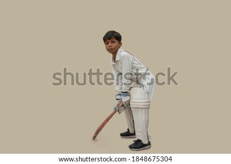Full length Portrait of boy Playing cricket Royalty-Free Stock Photo #1848675304