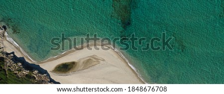 Aerial top down photo taken by drone of caribbean tropical beach with sapphire calm sea