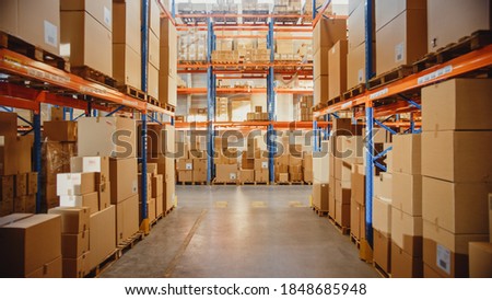 Retail Warehouse full of Shelves with Goods in Cardboard Boxes and Packages. Logistics, Sorting and Distribution Facility for Product Delivery. Royalty-Free Stock Photo #1848685948