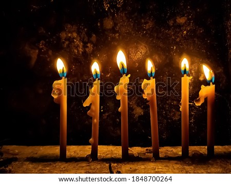Religious image of Jewish holiday Hanukkah background with book  (Traditional candlesticks) and candles