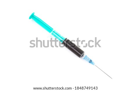 Medical syringe with black vaccine on white background