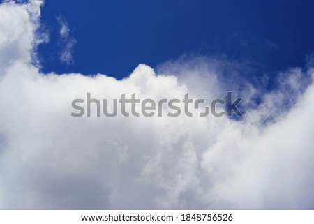 White cloud close-up against blue sky. Large white cloud.