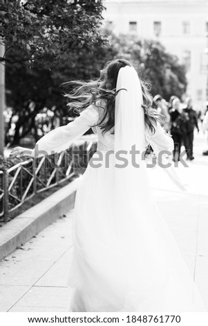 Happy bride in a wedding dress. Black and white photography