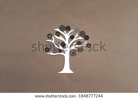 The tree is white, with a crown of iron gears on a light brown background. Interaction, business project.