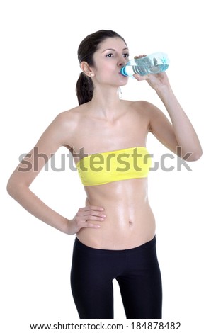 Beautiful woman drinking water after gymnastic exercises
