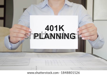  The 401k layout is written in a notebook held by a girl. High quality photo