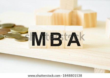  the word MBA is written on wooden cubes in the background also cubes. FAQ text on table, concept. High quality photo