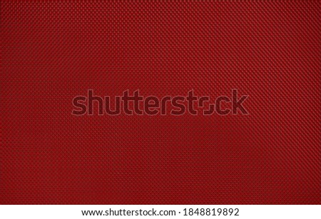 Red nylon fabric textured background with hexagonal shape