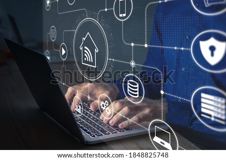 Connections and smart home technology with devices and computers connected on internet and local network, person configuring data communication and digital information security on laptop