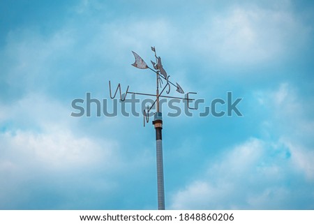metal object defining the side of the wind with direction letters on it Royalty-Free Stock Photo #1848860206