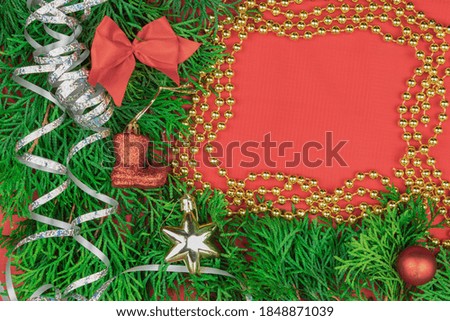 Christmas toys and serpentine as background with place for text. Traditional Christmas toys, balls and serpentine on a festive background. New Year Christmas concept.