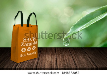 Save Zambia eco friendly green bag on table, non woven fabric shopping bag, future of Zambia, Use ECO Bag