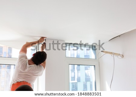 Installation of stretch ceiling. Niche for stretch ceiling. Stretch ceiling, work. Royalty-Free Stock Photo #1848883501