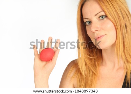 young woman using red stress ball  in white