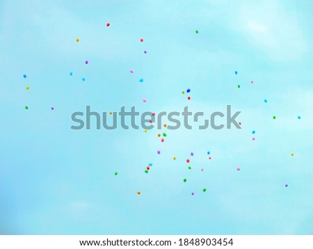 Festive balloons fly into the sky.
