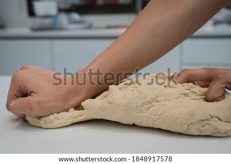 hands knead fresh artisan bread with yeast flour water on white base córdoba argentina