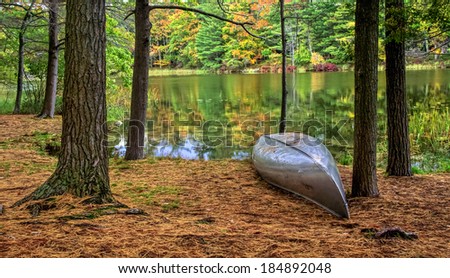 Autumn Lakeshore. Aluminum canoe along the forested lakeshore. Ludington State Park. Ludington, Michigan. Royalty-Free Stock Photo #184892048