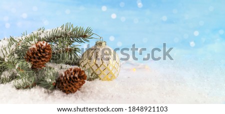 Holiday Christmas background. Christmas card background with Christmas background with golden ball. Christmas theme, fir branches and ball. Snow. copyspace