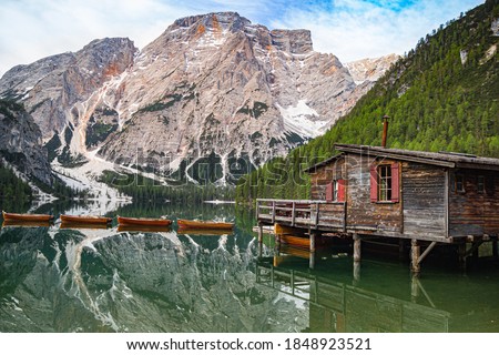 low angle view of Mount Seekofel and boatshouse mirroring in the clear calm water of iconic mountain lake Pragser Wildsee (Lago di Braies) in Dolomites, Unesco World Heritage, South Tyrol, Italy Royalty-Free Stock Photo #1848923521