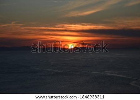 A magical sunset over the wavy lake