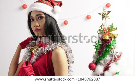 Beautiful woman with christmas tree and christmas gift