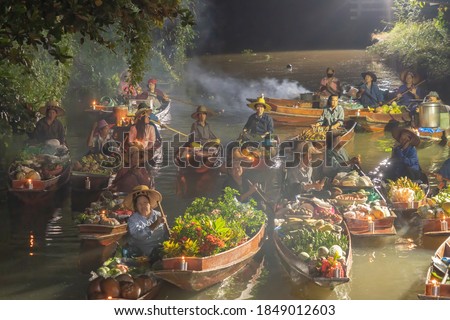 Damnoen Saduak Floating Market or Amphawa. Local people sell fruits, traditional food on boats in canal, Ratchaburi District, Thailand. Famous Asian tourist attraction destination. Festival in Asia. Royalty-Free Stock Photo #1849012603