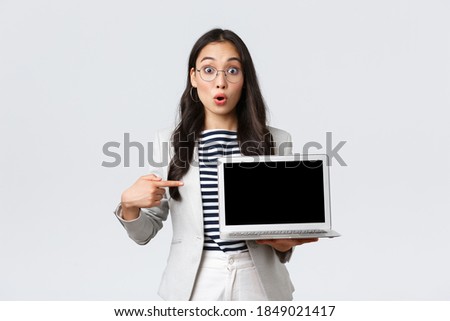 Business, finance and employment, female successful entrepreneurs concept. Enthusiastic businesswoman, asian office manager showing presenting on screen during meeting, pointing at laptop