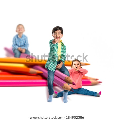 Kids around crayons isolated over white background