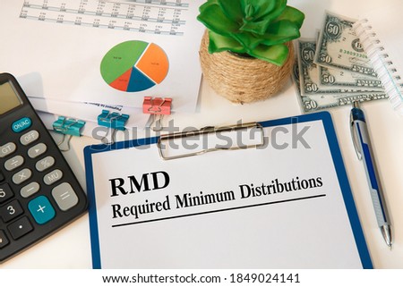 Paper with Required Minimum Distributions RMD on a table, calculator and documents