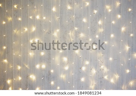 Christmas background - garland lights on grey wall