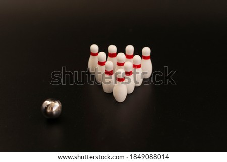white bowling pins on a black background.Business concept