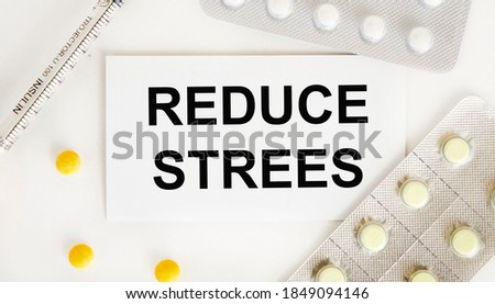 On the card text REDUCE STREES, next to blisters with tablets, syringe.