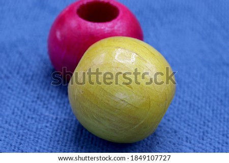 colorful wooden beads on a blue background

