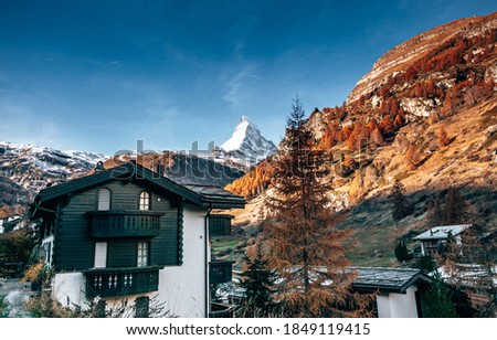 Matterhorn in a middle of a Zermatt village with autumn colours