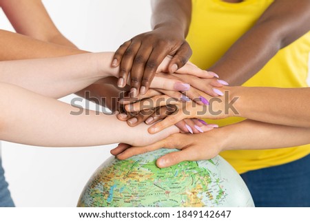 Colorful hands. Hands on the globe. Different races of people. One team called humanity. Racial tolerance. Joint action and existence. Royalty-Free Stock Photo #1849142647