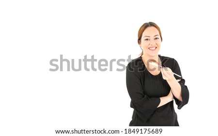 Attractive young woman holding a piece of tuna sushi with chopsticks against a white background