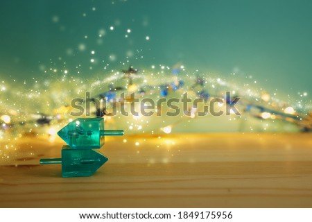 Banner of jewish holiday Hanukkah with wooden dreidels (spinning top) over wooden background