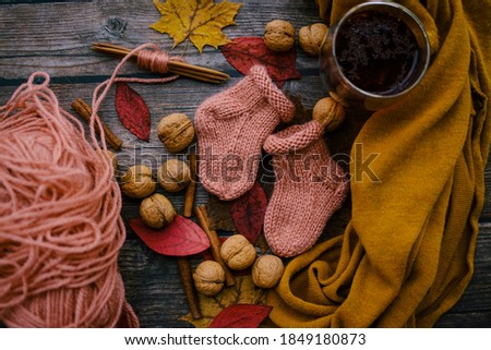 Soft and warm newborn socks on dark wooden background