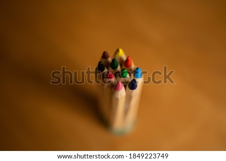Pencils of different colors grouped together