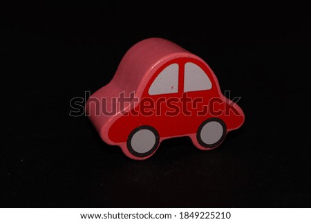 Red car shaped toy wooden stick