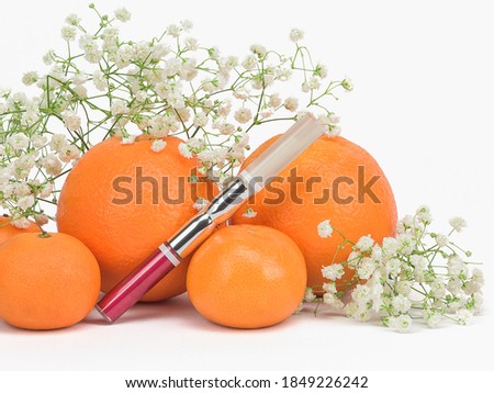 Red amaranth liquid lipstick and lip gloss oil with citrus extract, vitamin C. Fashion glamour cosmetic branding mockup with flowers and fruits on white background. Beauty packaging product concept
