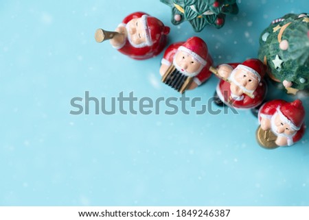 Flat lay Santa sing a song on Christmas caroling day Carolers singing with snows.Group of Santa claus play music singing carol song on celebration of christmas day in winter time.Holidays music.blue.